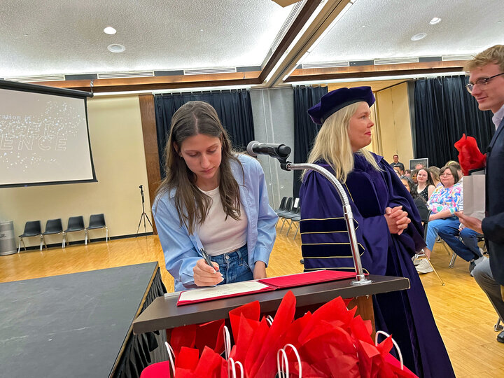 An inductee signing the roster at Spring 2024 Celebration of Excellence