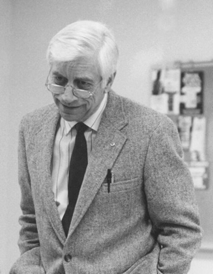 A black and white photo of Knoll with his hands in his pockets